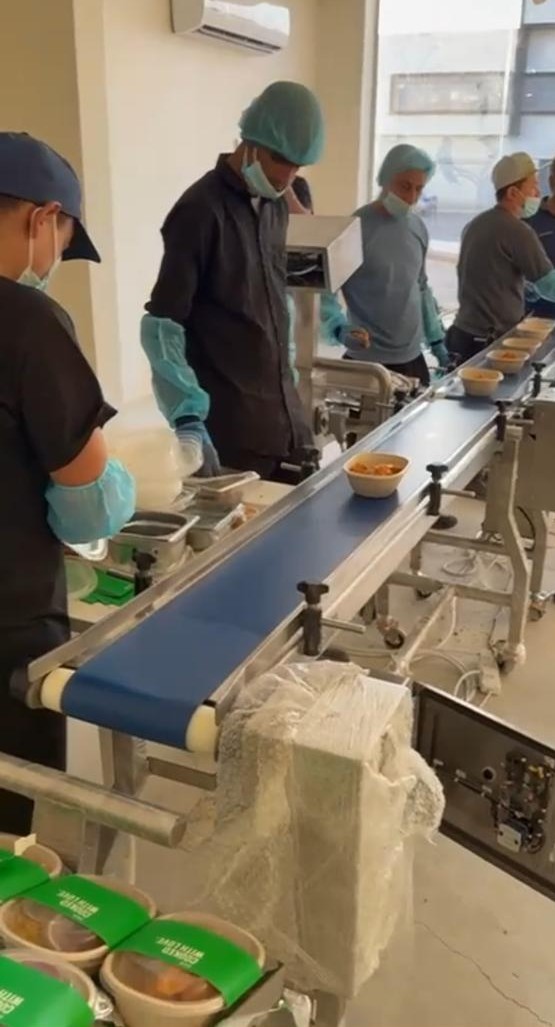 Food production conveyor and manual loading / inspection line.
