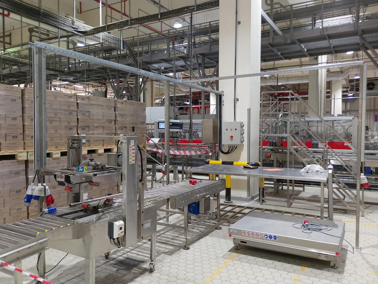 Integrated roller conveyor system in industrial line.